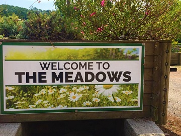 Welcome to The Meadows sign by the site entrance